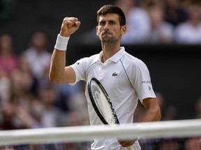 Serbia's Novak Djokovic celebrates winning against Italy's Matteo Berrettini during their men's singles final match on the thirteenth day of the 2021 Wimbledon Championships at The All England Tennis Club in Wimbledon, southwest London, on July 11, 2021.