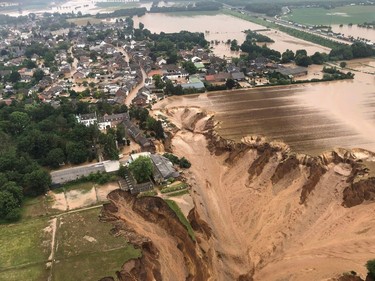 This handout photo obtained via the twitter account of the district government of Cologne (Bezirksregierung Köln) from the Rhein-Erft-Kreis on July 16, 2021 shows an aerial view over the flooded town of Erftstadt following heavy rains.