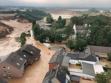 This handout photo obtained via the twitter account of the district government of Cologne (Bezirksregierung Köln) from the Rhein-Erft-Kreis on July 16, 2021 shows an aerial view over the flooded town of Erftstadt following heavy rains.