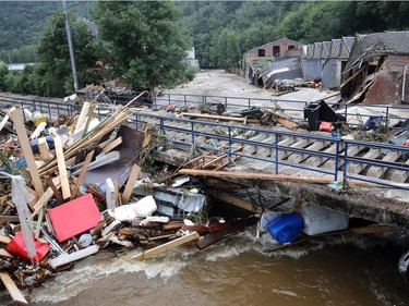 This picture taken in Pepinster on July 16, 2021 shows debris piled up next to a bridge after the flood. The situation remains critical as the water keep rising after the heavy rainfall of the previous days.
