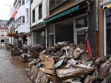 A local resident cleans up debris in a street in Bad Neuenahr-Ahrweiler, western Germany, on July 16, 2021, after heavy rain hit parts of the country, causing widespread flooding and major damage.