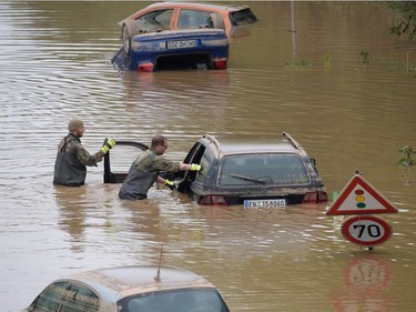 Soldiers of the German armed forces Bundeswehr search for flood victims in submerged vehicles on the federal highway B265 in Erftstadt, western Germany, on July 17, 2021, after heavy rains hit parts of the country, causing widespread flooding and major damage.
