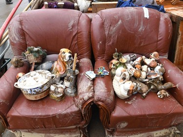 Furniture and other home decorations are placed outside a home during a clean-up following heavy rains and floods in the town of Rochefort on July 17, 2021.