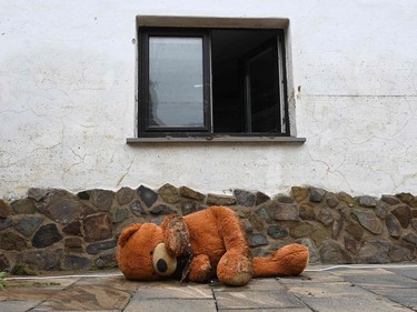 A big muddy teddy bear lies on the floor in front of a house after the floods caused major damage in Schuld near Bad Neuenahr-Ahrweiler, western Germany, on July 17, 2021.