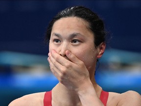 Canada's Maggie Mac Neil reacts after taking gold in the final of the women's 100m butterfly swimming event.