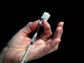 A file photo shows a nurse preparing a syringe of the Pfizer-BioNtech Covid-19 vaccine.