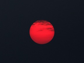 FILE: The sun rises through a cover of wildfire smoke in Ontario on July 20, 2021.