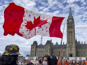 Indigenous people and their supporters crowd onto Parliament Hill for a #CancelCanadaDay march on Thursday, July 1, 2021.