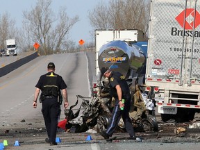Ontario Provincial Police traffic accident reconstructionists investigate the scene of the crash that killed four people and seriously injured two others in May 2017 on Highway 401 east of Kingston.