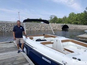 Sterling Bown with one of the Freedom Boat Club boats. He's hopeful the shortage in supplies won't mean he doesn't have enough boats for next summer.