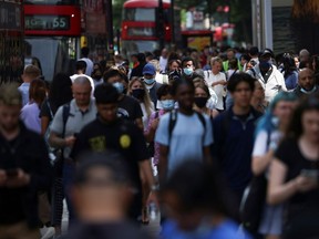 FILE PHOTO: People walk along Oxford Street, amid the coronavirus disease (COVID-19) outbreak, in London, Britain, July 26, 2021.