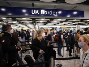 FILE PHOTO: Arriving passengers queue at UK Border Control at the Terminal 5 at Heathrow Airport in London