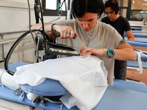 FILE PHOTO: A woman works at the Brunello Cucinelli factory in Solomeo village, near Perugia, Italy, September 4, 2018.