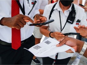 Security agents check visitors' health passes in front of the Louvre museum entrance amid the coronavirus disease (COVID-19) outbreak in Paris, France, July 21, 2021.