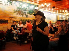 Pamela Pickens, of Madison, Ind., dances to live music as coronavirus disease (COVID-19) restrictions are eased at blues bar Kingston Mines in Chicago, Illinois, U.S