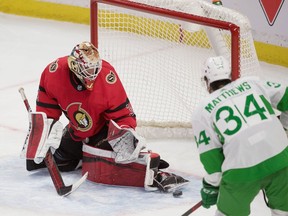 Ottawa Senators goalie Joey Daccord makes a save in front of Toronto Maple Leafs centre Auston Matthews.