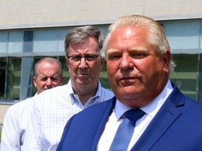 Premier Doug Ford is joined by Cameron Love, president and CEO of The Ottawa Hospital and Ottawa Mayor Jim Watson at a funding announcement at the hospital on July 26.