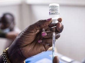 FILE: A nurse draws a dose of the AstraZeneca COVID-19 vaccine from a vial at Mbagathi Hospital in Nairobi, Kenya, on Tuesday, July 6, 2021. The highly contagious COVID-19 delta variant may spark a fourth wave of infections in Kenya over the next two months, according to the East African nation's Health Ministry.