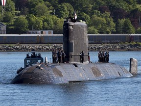 FILE: HMCS Windsor, one of Canada's Victoria-class long range patrol submarines, returns to port in Halifax on June 20, 2018. The Department of National Defence is pushing ahead with plans to extend the lives of Canada's four submarines, with the head of the navy hoping some work will start in the coming months. While Canada's submarines have a troubled history, Royal Canadian Navy commander Vice-Admiral Ron Lloyd says the fact one submarine was recently in Asia even as another was in the Mediterranean is proof the fleet has turned a corner.