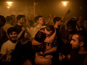 Two people hug in the middle of the dancefloor at Egg London nightclub in the early hours of July 19, 2021 in London, England.