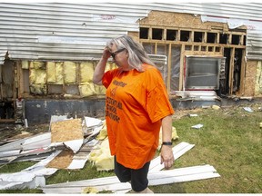 Parishoner Heather Knockwood walks past the fire-damaged exterior at St. Kateri Tekakwitha Church in Indian Brook, N.S. on Wednesday, June 30, 2021. The fire at the Roman Catholic Church that serves the Sipekne'katik First Nation, is believed to be suspicious in nature.