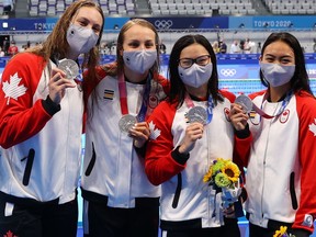 Silver medalists Kayla Sanchez, Margaret MacNeil, Rebecca Smith and Penny Oleksiak celebrate their silver medal in the Women's 4 x 100m Freestyle Relay.