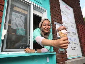 Ashrakat Elboraey, who agreed to remove her mask for this photo, serves ice cream at The Merry Dairy in Ottawa.