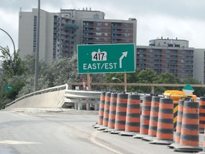 The westbound Queensway entrance at Greenbank/Pinecrest roads shows an eastbound sign.
