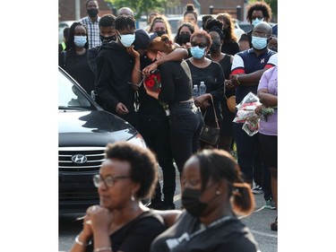 Family, friends and the community gathered on York Street to hold a vigil for Loris Tyson Ndongozi on Tuesday. Ndongozi, 20, was fatally shot Sunday night in Ottawa in what his family called the senseless killing of a gentle giant.