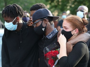 Family, friends and the community gathered on York Street to hold a vigil for Loris Tyson Ndongozi on Tuesday. Ndongozi, 20, was fatally shot Sunday night in Ottawa in what his family called the senseless killing of a gentle giant.