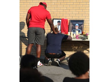Family, friends and the community gathered on York Street to hold a vigil for Loris Tyson Ndongozi on Tuesday. Ndongozi, 20, was fatally shot Sunday night in Ottawa in what his family called the senseless killing of a gentle giant.