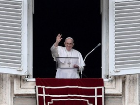 Pope Francis waves as he delivers the Sunday Angelus prayer from the window of his study overlooking St.Peter's Square at the Vatican on July 25, 2021.