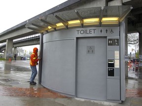 Installation crews finish their work as the first of eight automated free public toilets opens in Vancouver in 2007.