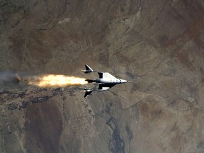 FILE PHOTO: Virgin Galactic's VSS Unity, piloted by CJ Sturckow and Dave Mackay, starts its engines after release from its mothership, VMS Eve, on the way to its first spaceflight after launch from Spaceport America, New Mexico, U.S. May 22, 2021 in a still image from video.