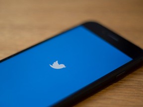 In this file photo taken on July 10, 2019 The Twitter logo is seen on a phone