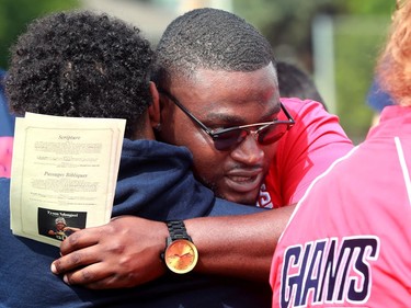 Hundreds of people showed up on Friday, July 16, 2021 for a Celebration of Life to honour Loris Tyson Ndongozi at the football field Tyson knew and loved. Former teammates give each other a hug before the celebration. 

Hundreds of people showed up for a Celebration of Life to honour Tyson Ndongozi at the football field Tyson knew and loved. 

He was killed on July 4th while playing pickup basketball with a friend. 

Julie Oliver/POSTMEDIA