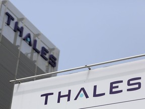 A logo sits on a sign outside the offices of Thales U.K. Ltd., a unit of Thales SA, in Crawley, U.K., on Friday, July 12, 2013. Photographer: Chris Ratcliffe/Bloomberg