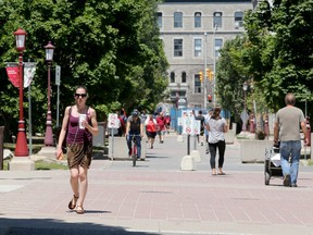 File photo/ Some students and faculty mill around campus at University of Ottawa.