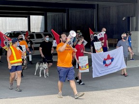 Border services officers and union officials marched towards the entry gate to Canada at the Lansdowne border crossing Thursday.