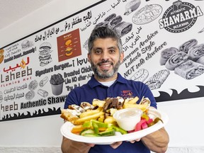 Laheeb Flaming Hot co-owner Osama Abu Daqqa displays a SAJ beef shawarma meal at his Somerset Street restaurant.