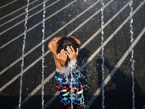 FILE: A child cools off in a fountain.