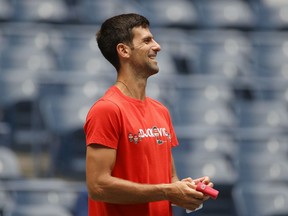 Files: Novak Djokovic of Serbia smiles during a practice session prior to the start of the 2021 US Open at USTA Billie Jean King National Tennis Center on August 28, 2021.