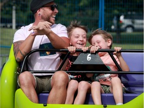 David Verge has a blast with his two boys, Félix, 9, and Mattis, 5, while on the Sizzler at the Kanata Family Fun Fair, which took place this weekend at the Kanata Recreation Complex with safety protocols in place.