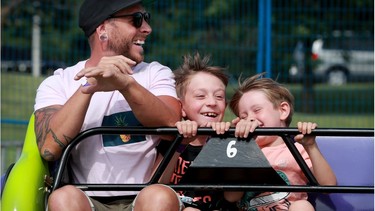 David Verge has a blast with his two boys, Félix, 9, and Mattis, 5, while on the Sizzler at the Kanata Family Fun Fair, which took place this weekend at the Kanata Recreation Complex with safety protocols in place.