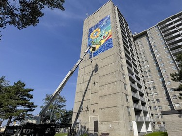 Installation of artist Claudia Salguero's five-storey Wisdom Mural project was completed Friday on the side of an Ottawa Community Housing building near the Billings Bridge shopping centre.