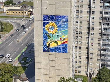 Installation of artist Claudia Salguero's five-storey Wisdom Mural project was completed Friday on the side of an Ottawa Community Housing building near the Billings Bridge shopping centre.