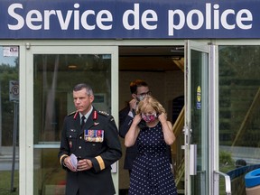 General Dany Fortin exits the Gatineau Police Service headquarters with his lawyer, Philippe Morneau, and his wife, Madeleine Collin, on Wednesday.