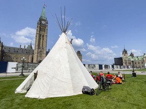 Participants in the 500-kilometre Blinding Light-Tiger Lily walk have erected a teepee on the front lawn of Parliament Hill.