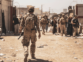 A Canadian soldier walks through an Evacuation Control Checkpoint during an evacuation at Hamid Karzai International Airport in Kabul, Afghanistan, August 24, 2021.