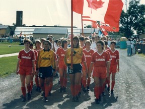 Canadian players including Carla Chin and Sue Redepenning-Simon march onto the field before one of their two 1986 games in the U.S. North American Cup (at the Sons of Norway youth tournament) 7 July 1986 - Blaine, MN, USA Photo: Canada Soccer.